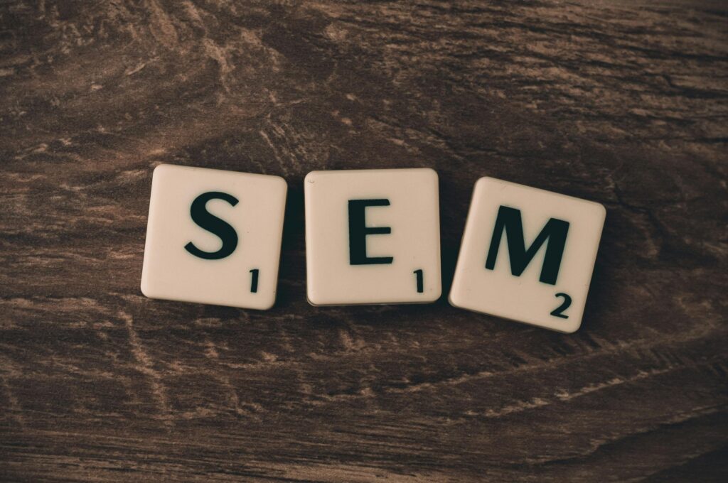 pexels-photo-267414-267414 Wooden background with letter tiles spelling SEM, representing search engine marketing.
